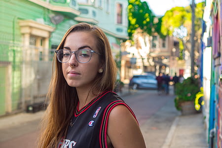 selective focus photography of woman wearing eyeglasses and NBA jersey thumbnail