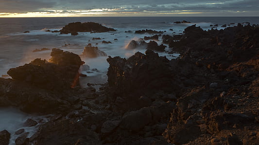 rock formation surrounded of body of water thumbnail