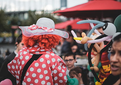 person wearing polka-dot suit standing beside people thumbnail