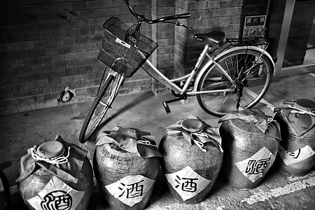 Bike with jugs of wine black and white thumbnail