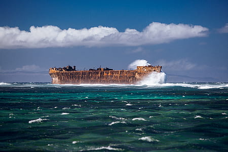 island under blue sky and white clouds during daytime thumbnail