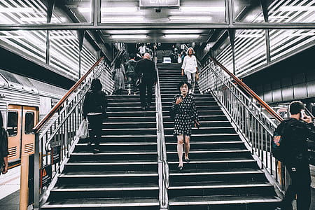 photo of people walking up and down on subway stairs thumbnail