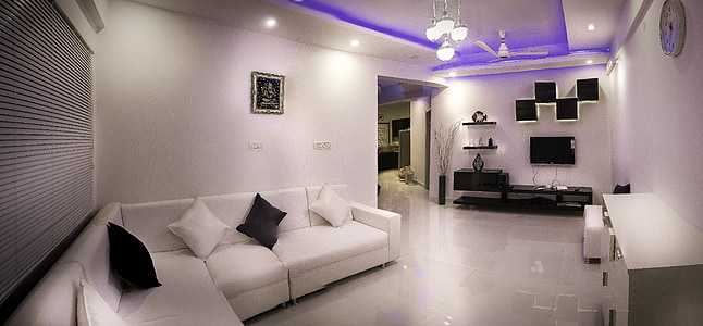 white sectional couch in front of white wooden sideboard thumbnail