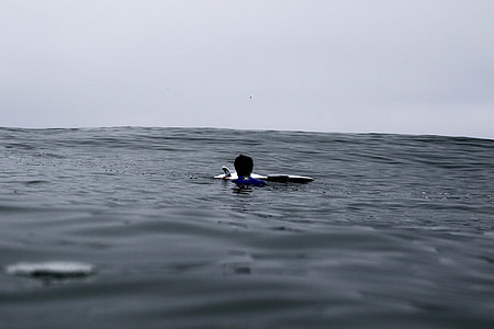 grayscale photo of person floating on water thumbnail