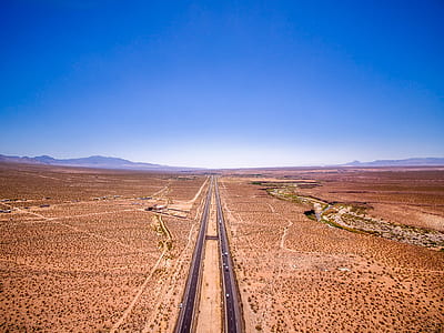 aerial photography of road under blue sky at daytime thumbnail