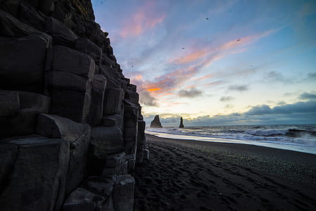 rock formation beside body of water thumbnail