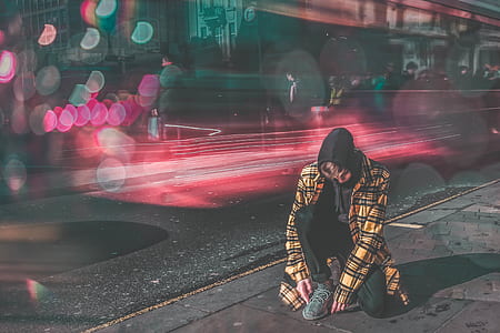 man holding his shoe with bokeh lights thumbnail