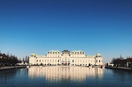 white stone wall palace near body of water thumbnail
