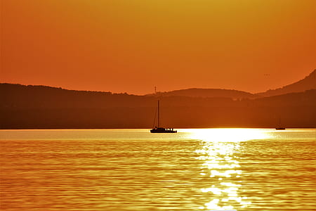 boat in body of water during golden hour thumbnail