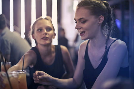 Two young blonde women sitting in a bar and enjoying the drinks thumbnail