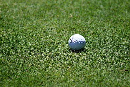 golf ball on green grass at daytime thumbnail