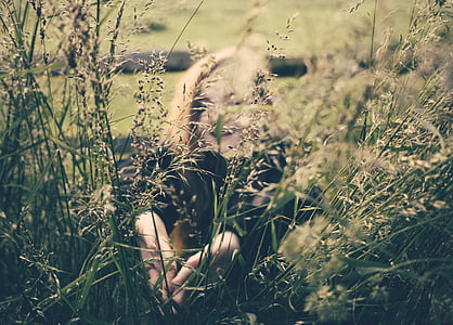 smiling woman behind grass at daytime thumbnail