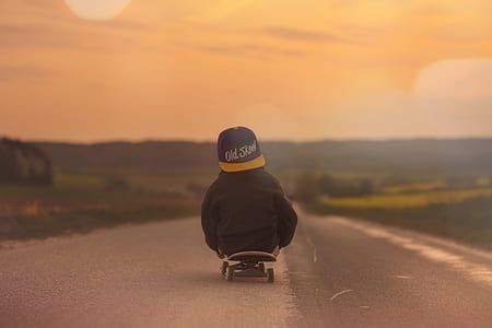Child in Black Jacket Blue Yellow Old School Print Fitted Cap Riding Skatebaord thumbnail