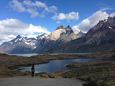 person standing on gray gravel looking at moutains thumbnail