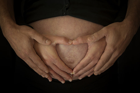 woman holding her tummy with man thumbnail