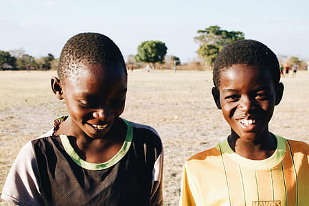 boy in black and green crew-neck shirt beside other boy in green and orange crew-neck shirt thumbnail