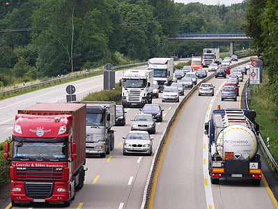 trucks and cars on a road during daytime thumbnail