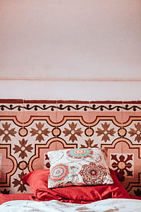 white, red, and teal pillow on top of red cloth thumbnail