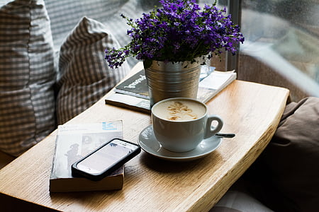 white ceramic teacup on white ceramic saucer on table thumbnail