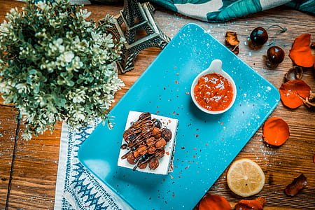 cooked food with red sauce on blue ceramic tray thumbnail