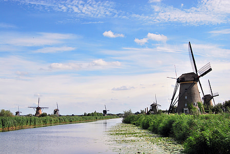 black windmills near river thumbnail