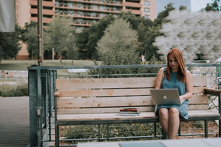woman sitting on bench using laptop thumbnail