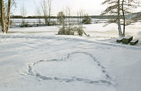 heart shape on snow at daytime thumbnail