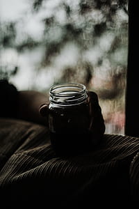 person holding clear glass jar thumbnail