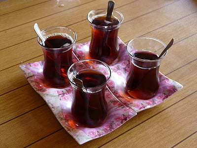 four glass turkish tea glass filled of purple liquid substance thumbnail