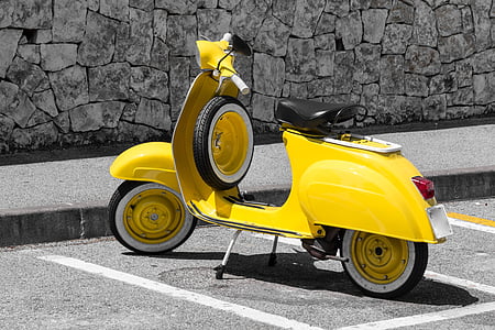 yellow motor scooter parked at side of street thumbnail