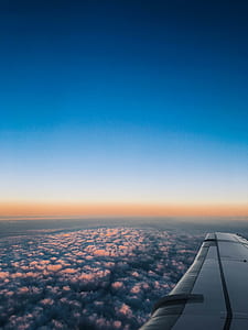 photo of clouds taken from inside an airplane thumbnail
