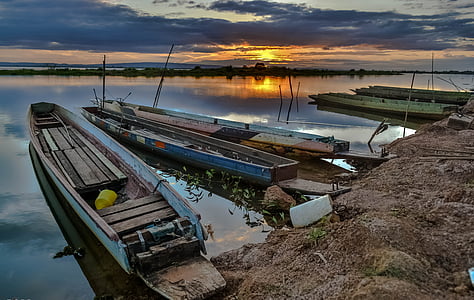 blue and brown boat on body of water thumbnail