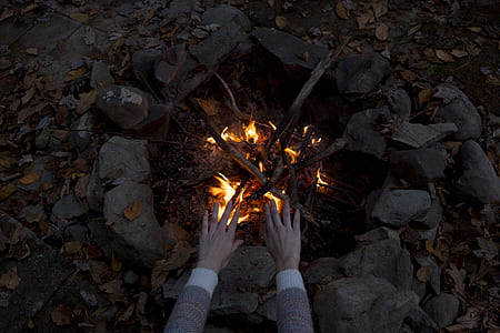 person near on bonfire during nighttime thumbnail
