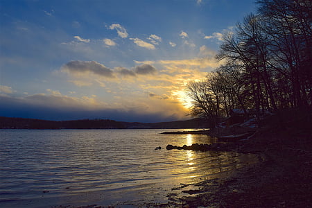 body of water under blue cloudy sky during daytime thumbnail