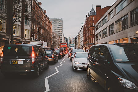 busy street with vehicles surrounded by buildings thumbnail