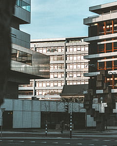 man walking near high rise building thumbnail