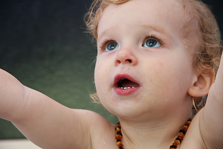 baby wearing black and brown beaded necklace thumbnail