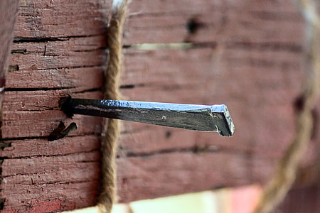 close up photo of gray nail on wall thumbnail