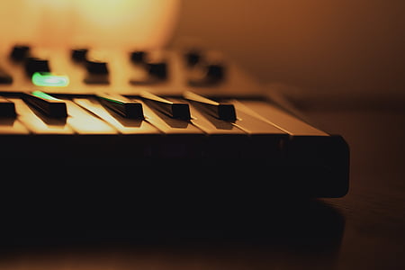 music, keyboard, lamp, keys, wooden desk, orange light thumbnail