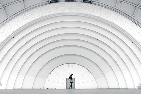 woman standing in front of white building thumbnail