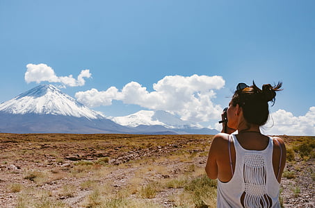 woman wearing white tank top on open field during daytime thumbnail