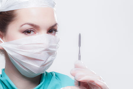 woman wearing face mask and holding scalpel knife thumbnail