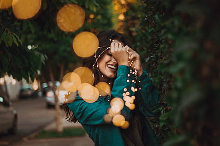 woman holding string of lights thumbnail