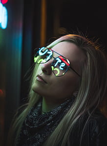 woman wearing eyeglasses while staring to neon light signage thumbnail