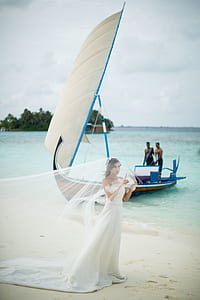 woman in white wedding gown on beach thumbnail