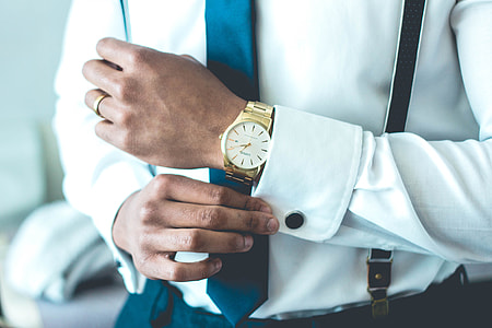 man holding his white dress shirt sleeve thumbnail