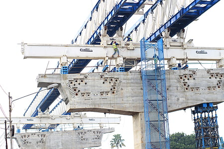 white and blue bridge construction during daytime thumbnail