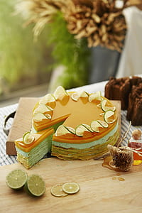 sliced of gray and orange lemon cake on brown table thumbnail