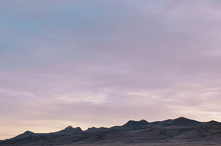 mountains under grey cloudy sky thumbnail