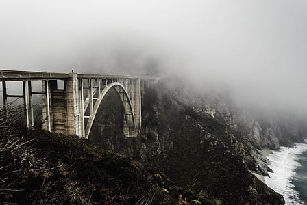 landscape photography of metal bridge near body of water thumbnail